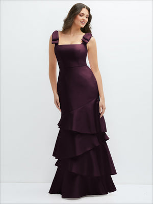 Burgundy satin maxi dress with bow shoulders and asymmetrical tiered ruffle skirt