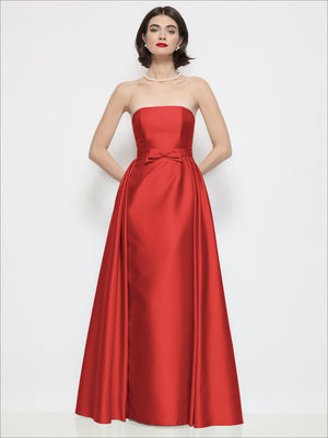 Red strapless satin column dress with waist bow detail and full skirt