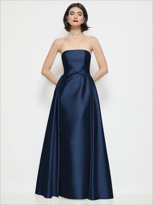 Navy strapless satin dress with waist bow detail and voluminous full skirt