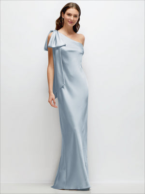 Light blue one-shoulder satin maxi dress with cascading shoulder bow and long draped skirt