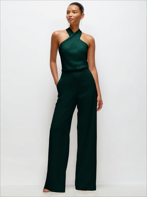 Dark green pleated halter jumpsuit with high neckline and straight wide-leg legs