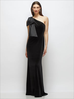 Black one-shoulder velvet maxi dress with large trailing satin bow