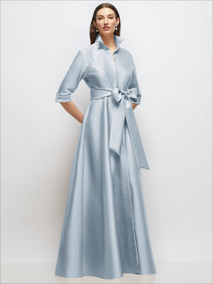 Light blue satin shirt dress with 3/4 sleeves, bow sash at waist, front buttons