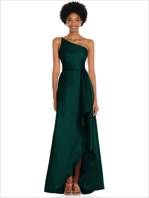 One-shoulder satin gown in deep green with draped front and high slit overlay