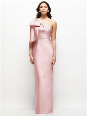 Blush pink one-shoulder satin column maxi dress with oversized bow at neckline