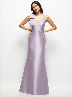 Lilac satin trumpet dress with deep V-back and one-shoulder cascading bow.
