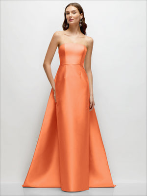 Peach/orange strapless satin column dress with fitted waist and draped train panel